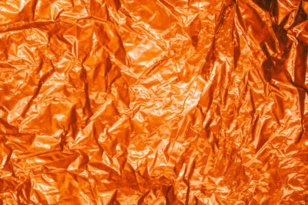 creased metal foil sheet in trendy golden colorの写真素材
