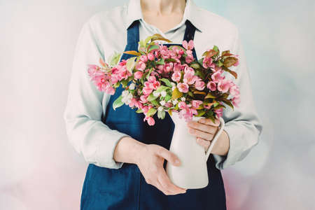 Woman or florist holding a bunch of pink spring flowersの写真素材
