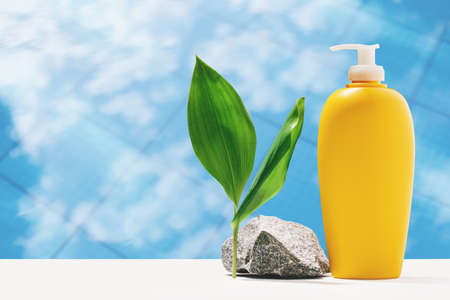 Sky in swimming pool, sunscreen lotion yellow bottle