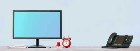 Computer blue monitor mockup for your design and alarm clock rocket and calculator and VOIP phone on...