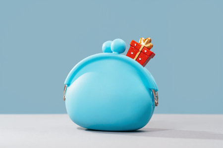 Red gift box in blue coin purse. Birthday or Mothers Fathers day gift card and voucher. Bank or store discount offerの写真素材