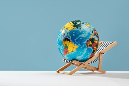 world globe resting on sun bed chair. Earth day. Global health care taking break or retirement and travel concept. Save the planet. Working or studying remotely concept. Vacation destinationの写真素材