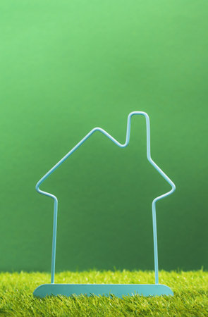 Property investment and house mortgage financial real estate concept. Percentage sign within house frame on green. Energy saving household. Insurance agent hand. or protection feeの写真素材
