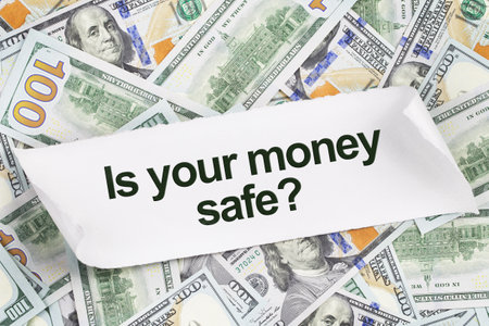 Background of US dollar bills with text. Is your money safe. banking crisis and savings concept. on a piece of paperの写真素材