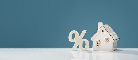 Percentage and house on white desk. mortgage calculator or real estate business concept banner. Listing. Down payment. Loan or insurance rate payments. Liability and riskの写真素材
