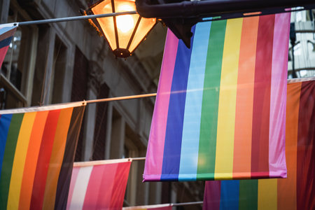 Different LGBTQ pride and rainbow flags hanginging in two rows in city market space. Londonの写真素材