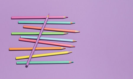 Colored pastel encils on lilac violet background. Back to School or drawing and creativity concept. Copy space. Top view bannerの写真素材