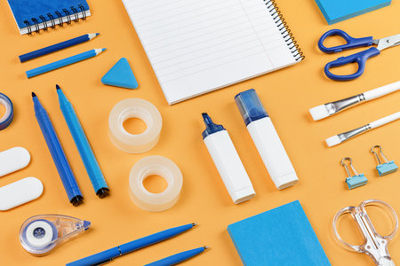 Assorted office and school white and blue stationery on bright yellow background. Organized knolling for back to school or education and craft concept. Selective focus. filled frameの写真素材