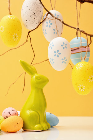 Happy Easter concept with eggs and bunny with sweets and candies. Egg hunt with twigs. Copy spaceの写真素材