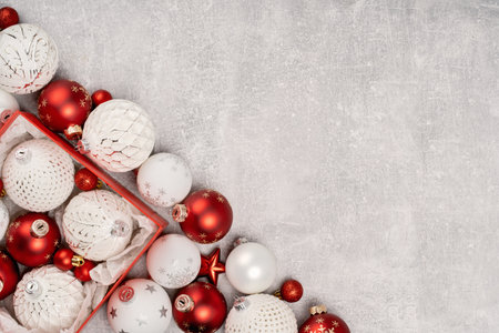 Red and white Christmas baubles in a box flat lay. Merry Christmas and Happy New Year seasons greetings card. Copy space. Festive borderの写真素材