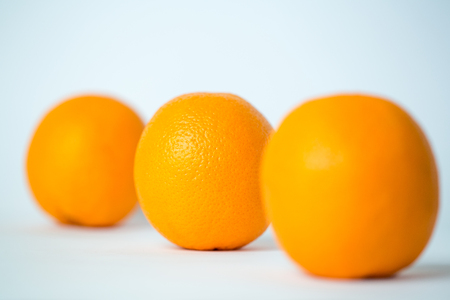 Three tasty orange fruits isolated on white backgroundの写真素材