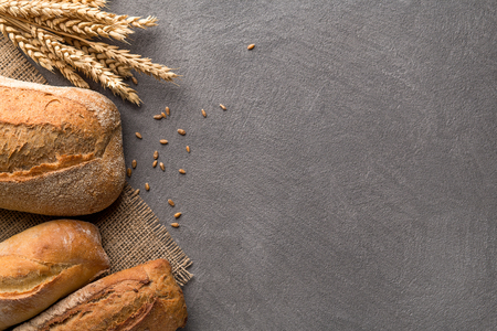 Bread background with wheat, aromatic crispbread with grains, copy space, top view. Bakery and grocery food store concept.の写真素材