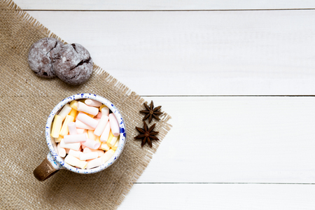 Cup of colorful marshmallows on the white wooden table, top view, copy spaceの写真素材