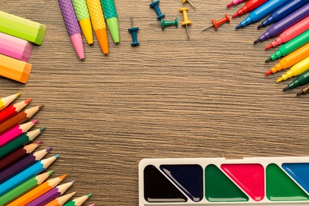 Bright school accessories, stationery on a wooden background. View from aboveの写真素材