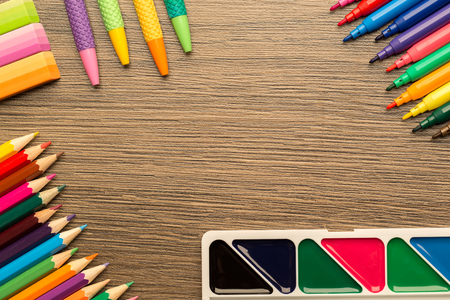 Bright school accessories, stationery on a wooden background. View from aboveの写真素材