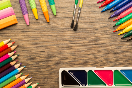 Bright school accessories, stationery on a wooden background. View from aboveの写真素材
