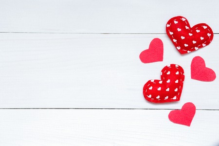 Valentine's day background with red hearts on the white wooden table, top view, copy spaceの写真素材