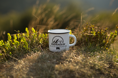 Cup of hot tea on background of nature during the sunset . Concept adventure active vacations outdoor. Summer camp in the mountainsの写真素材