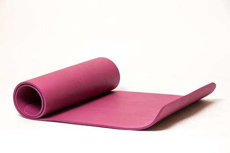 Pink yoga mat on white background, isolated, copy spaceの写真素材