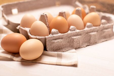 Eggs tray on white table, eggs with selective focus, close up