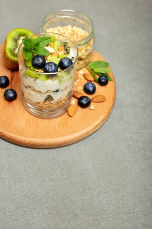 Healthy breakfast with granola, yogurt, berries and nuts. Copy space, close upの写真素材