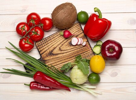 Menu food background. Wooden rustic cutting chief  board with vegetables on wooden background top view, copy spaceの写真素材