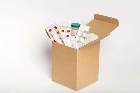 Delivery of medicines home from pharmacy. Cardboard box with medicines isolated on white