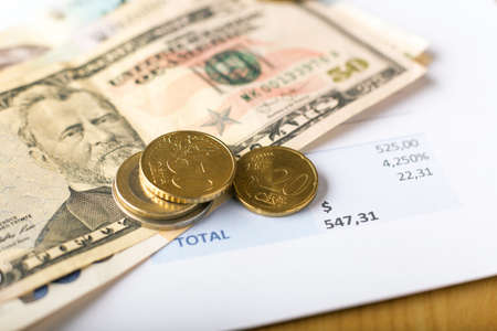 Invoice documents, dollar and euro money banknotes on table, financial and business concept