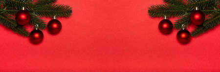 Red Christmas balls banner on red background, red baubles. New year concept.