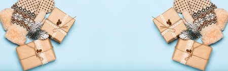 Christmas banner gift box with mittens on blue background. Holidays conceptの写真素材