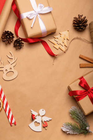 Christmas decorations flatlay, kraft gifts, red ribbon, wood toys. Christmas background conceptの写真素材