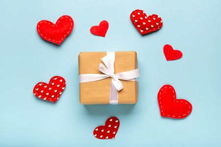 Valentine's Day background. Gift box, hearts on blue pastel background. Flat lay, top view, copy spaceの写真素材