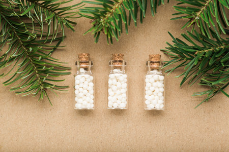 Homeopathy border background, globules in bottles and pine on cork background. Naturopathy and alternative medicine copy spaceの写真素材
