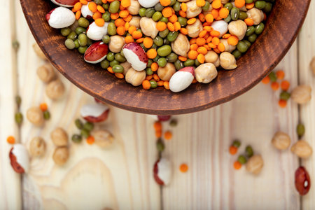 Bowl with different raw legumes on table close up, top view, copy space. Vegan protein sourceの写真素材