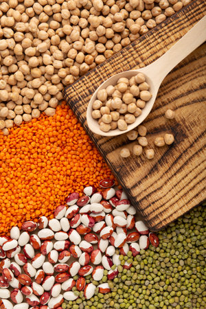 Chickpea seed on wooden spoon with various of legumes top viewの写真素材