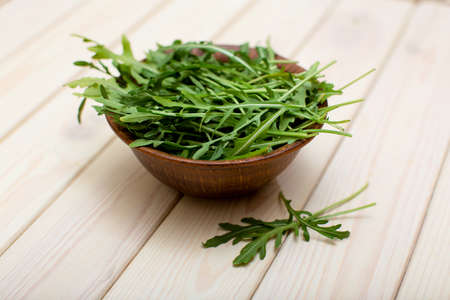 Fresh green aragula or rucola leaves salad in bowl close-upの写真素材