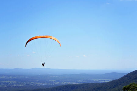 A paraglider soars on the updraftの写真素材