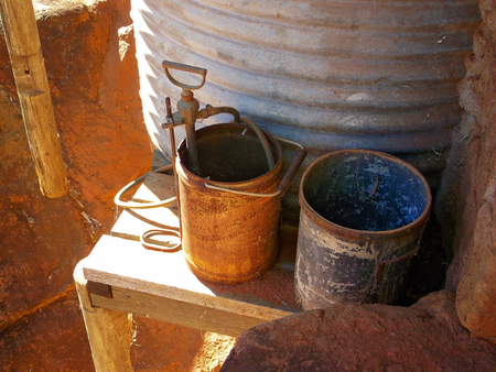 rusted buckets by water tankの写真素材