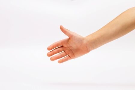 childs outstretched hand on a white background with an open palm.の写真素材
