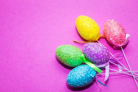 on a pink background close up of colored Easter eggsの写真素材