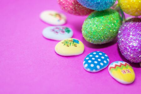 on a pink background close up of colored Easter eggsの写真素材