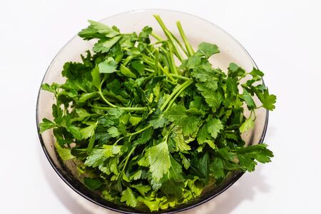 fresh parsley in a bowl on a white background close upの写真素材