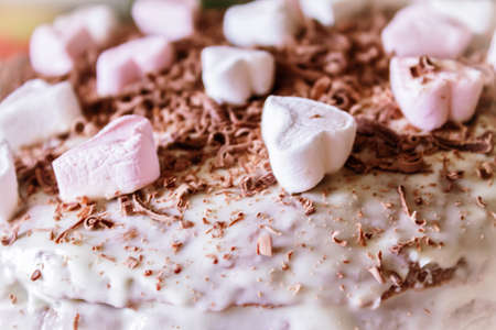 Festive cake with cream and chocolate, decorated with hearts close-up.の写真素材