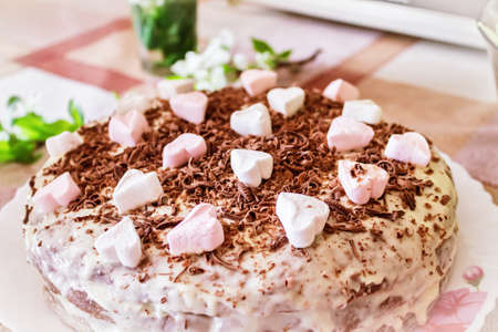 Festive cake with cream and chocolate, decorated with hearts close-up.の写真素材