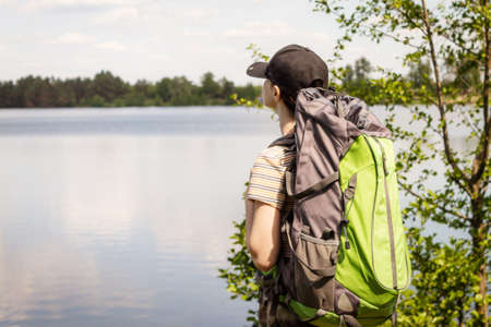 A young girl travels with a backpack and pants militari. Enjoys the view.の写真素材