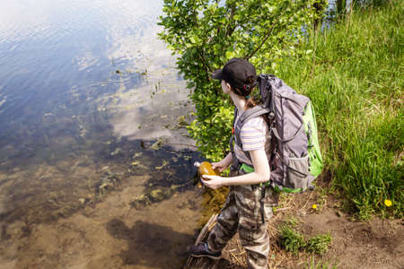 A young girl travels with a backpack and pants militari. Enjoys the view.の写真素材
