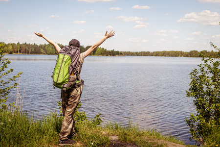A young girl travels with a backpack and pants militari. Enjoys the view.の写真素材