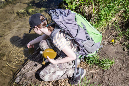 A young girl travels with a backpack and pants militari. Enjoys the view.の写真素材