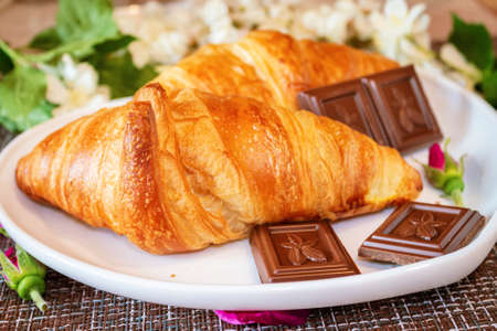 Romantic breakfast. Croissants, chocolate and coffee with marshmallows. Dishes in the form of hearts.の写真素材