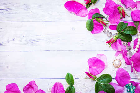 Romantic background. On a white sheet rose petals, decorations and candles close-up.の写真素材
